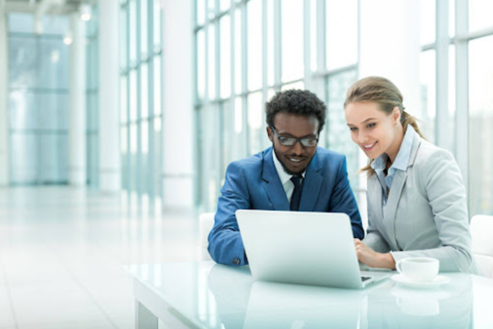 Employment lawyer in Ontario reviewing severance package documents with client during consultation in Oakville office