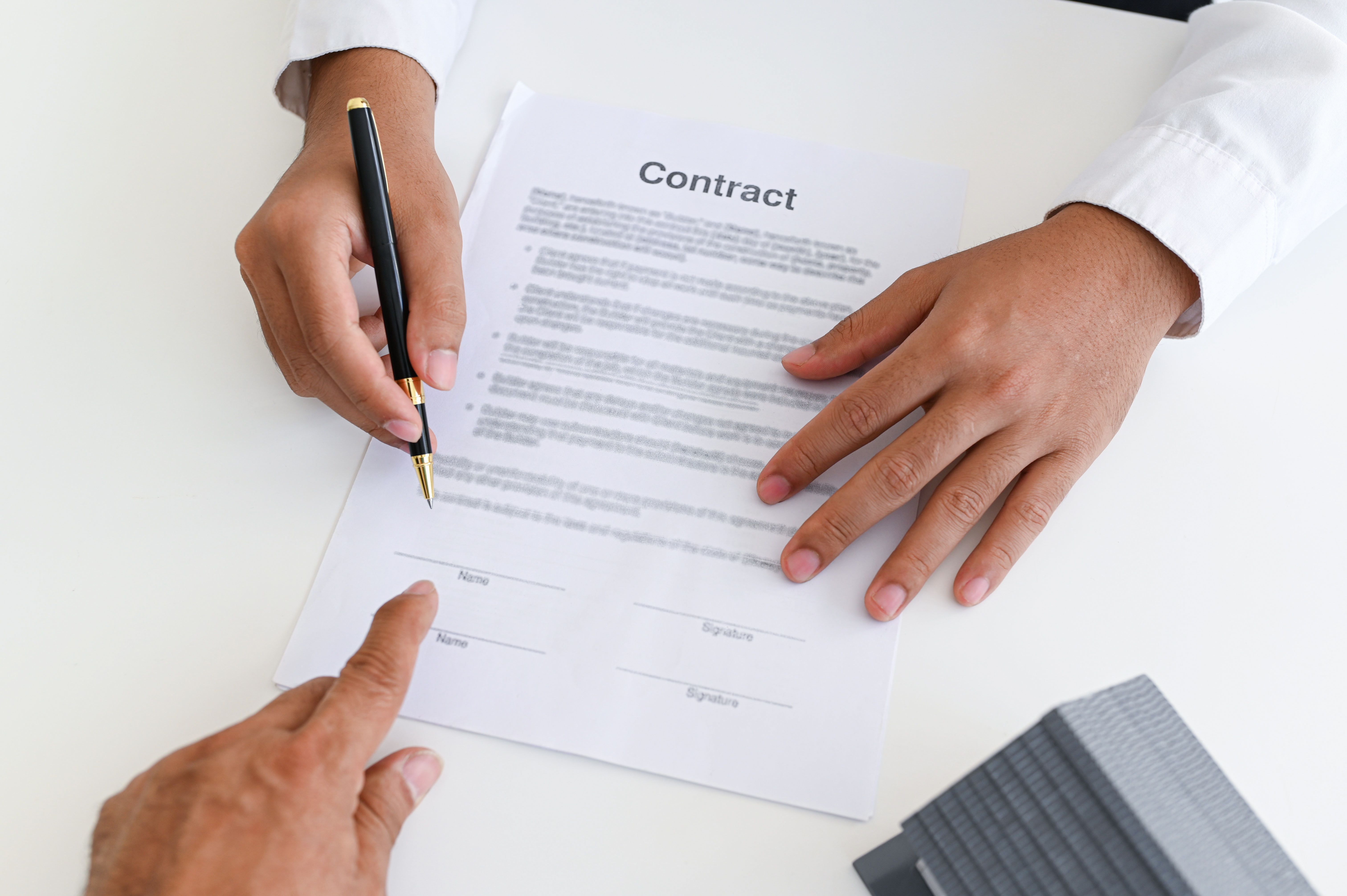 Employee reviewing an employment contract with an employment lawyer in Ontario.